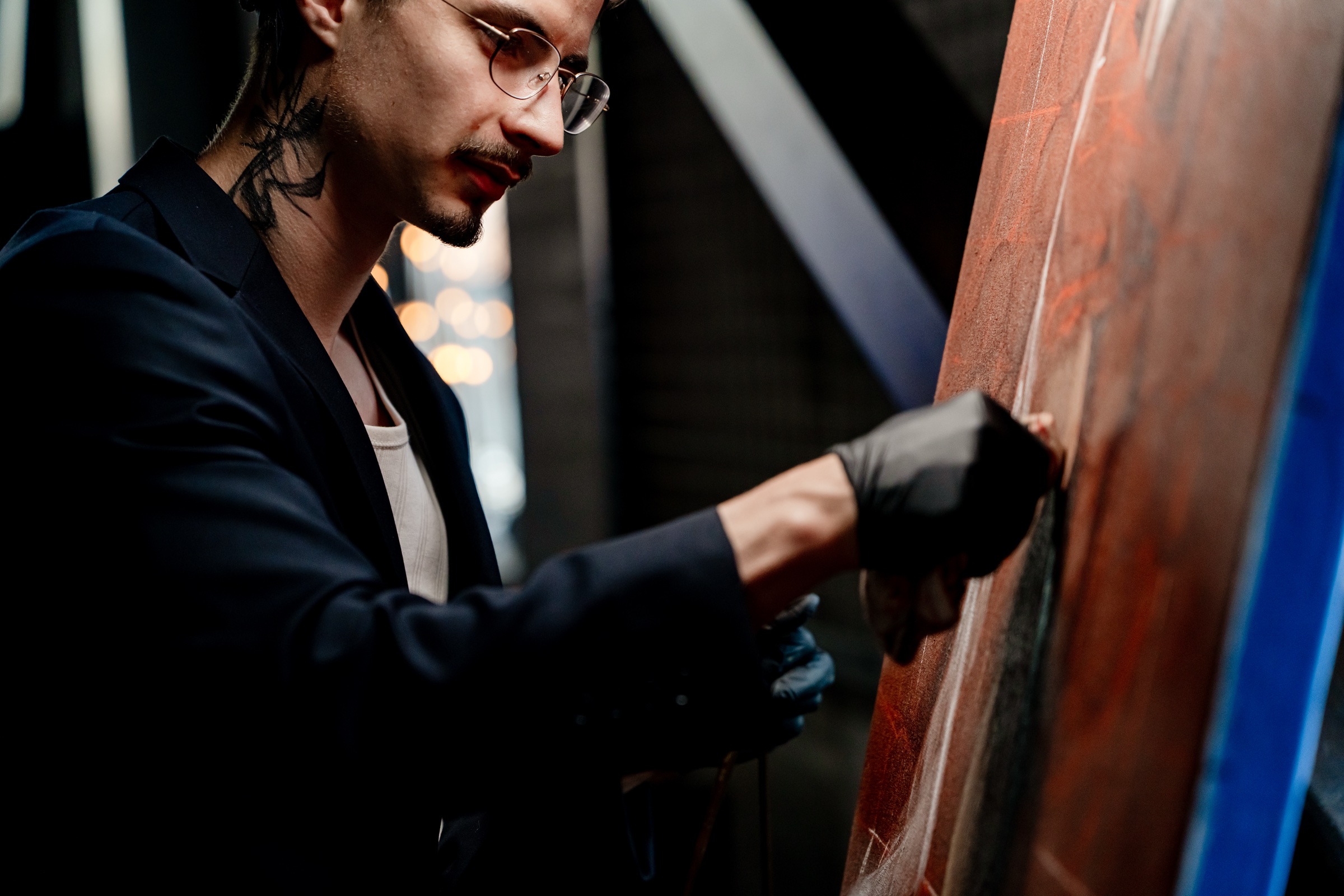 Nicholas Kontz painting live at a wedding, seen closely beside the canvas.
