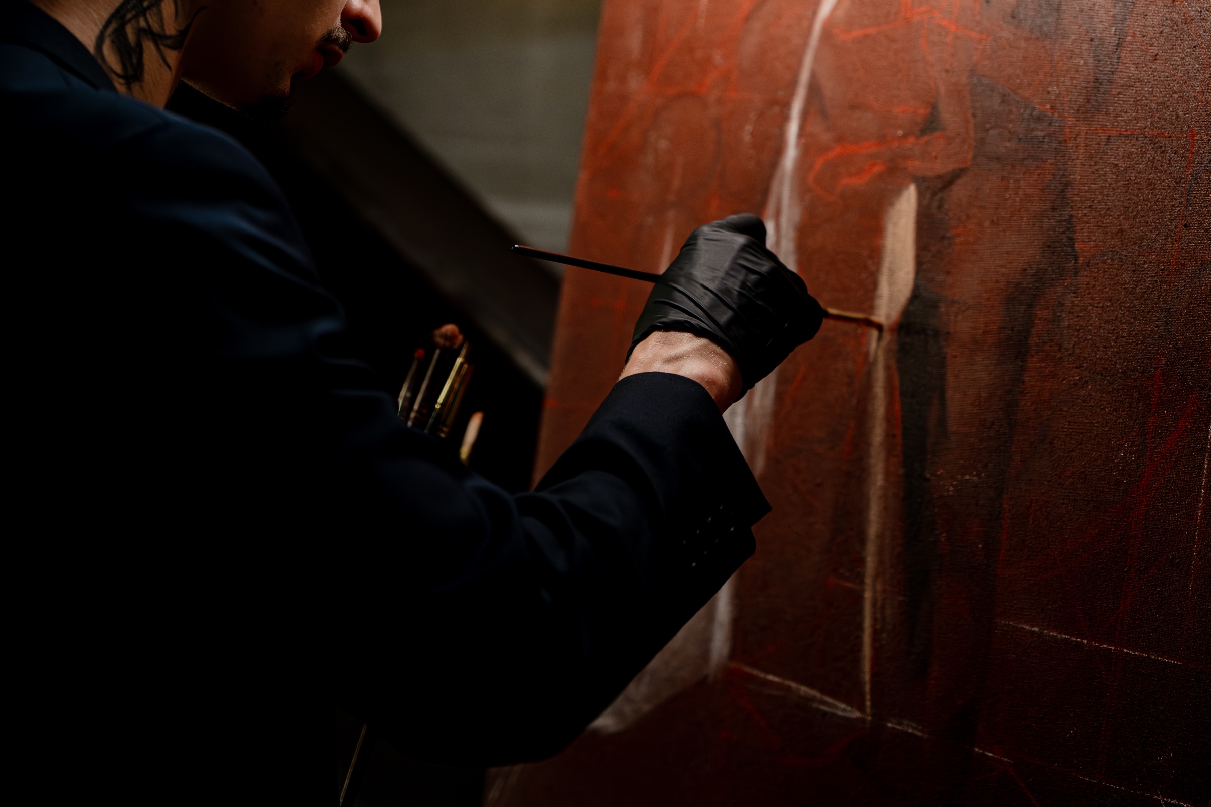 A close view of Nicholas Kontz painting a wedding portrait in oil.